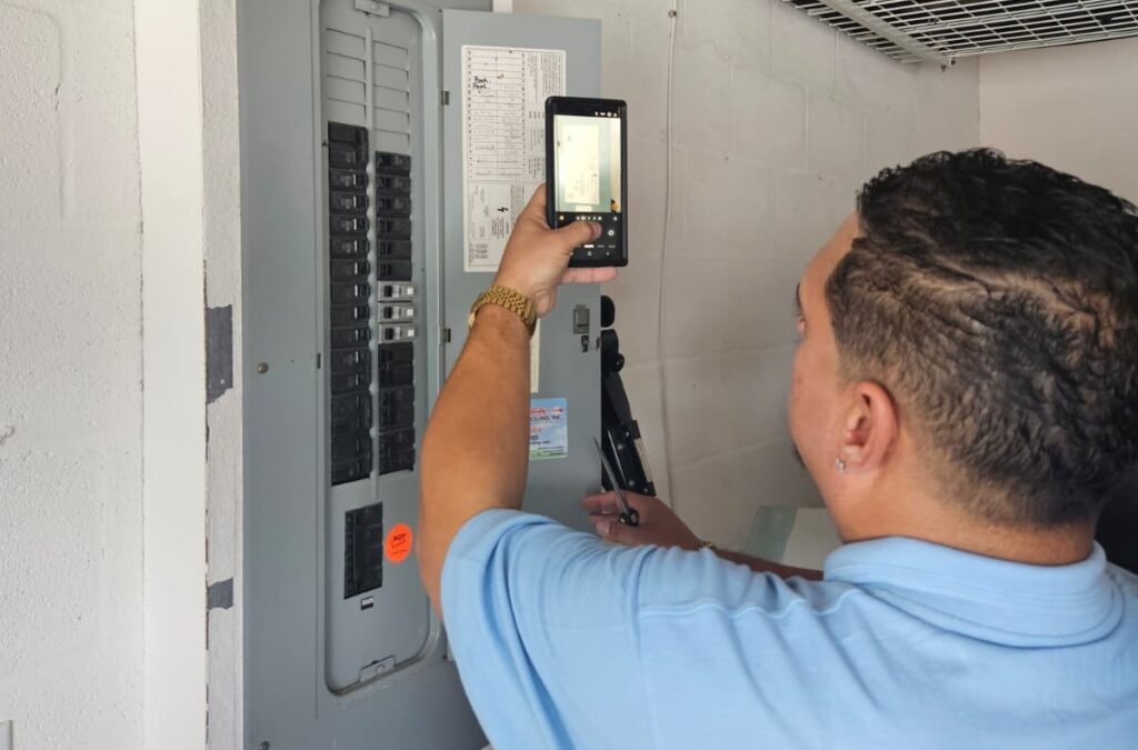home inspector inspecting an electrical panel