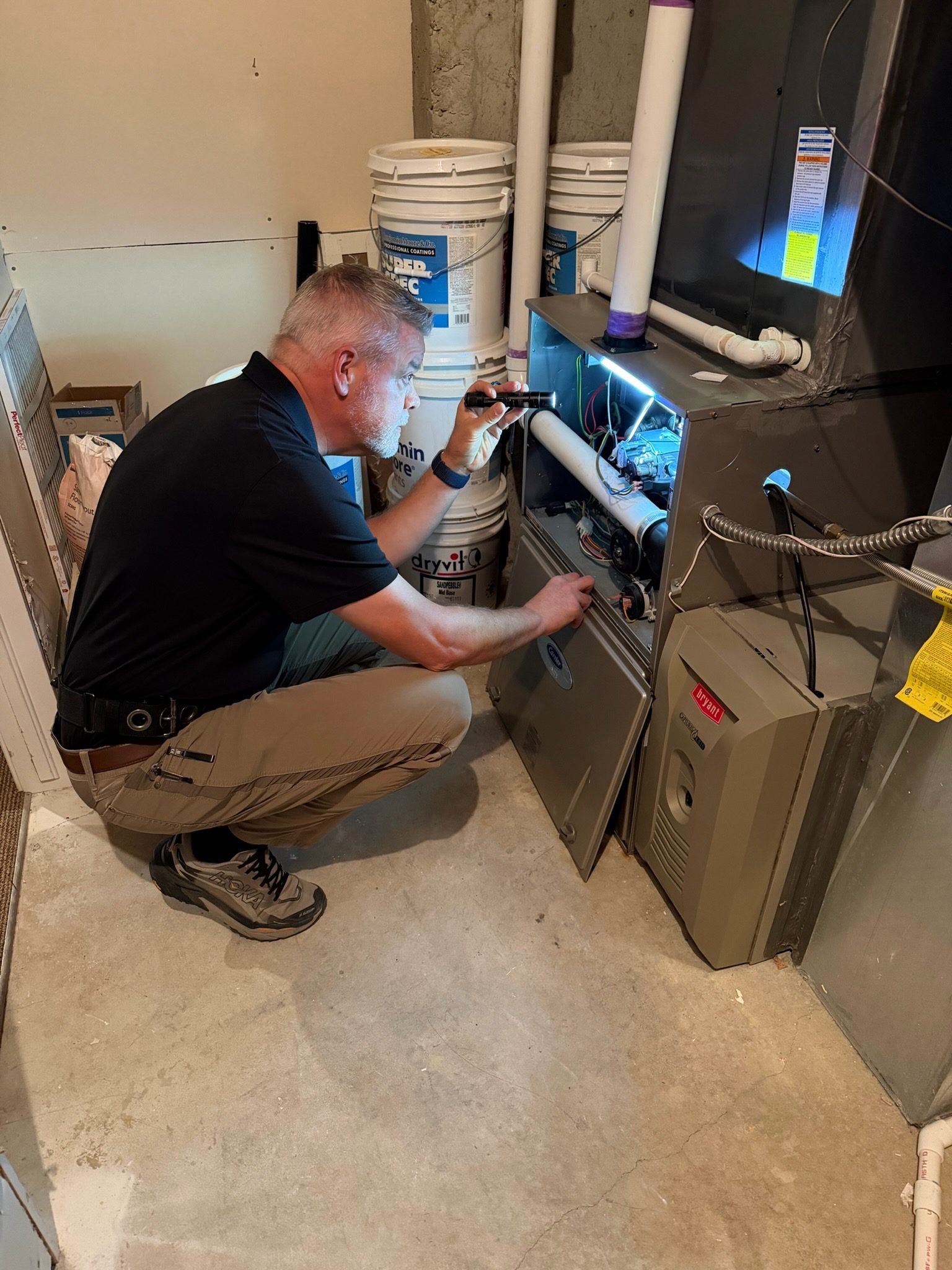 Home inspector examining a furnace during a Boulder property inspection